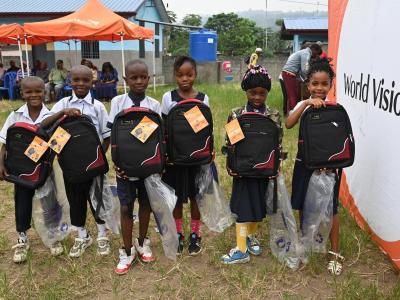 Children happy to receive school bags