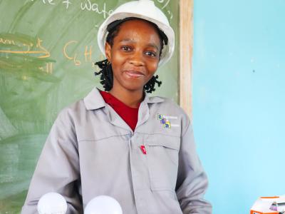 Nokwanda next to a model she has created with the skills she has acquired as an electrician.