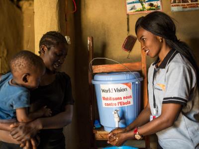 A World Vision employee teaching how to properly wash hand