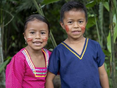 Children from the Ecuadorian Amazon smile at the camera.