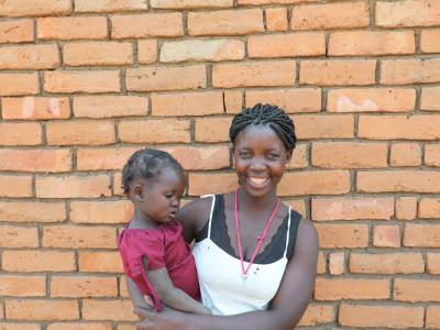 Rosita smiles and holds her daughter Gilda