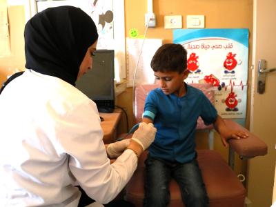 A child is receiving health cares in a clinic supported by World Vision