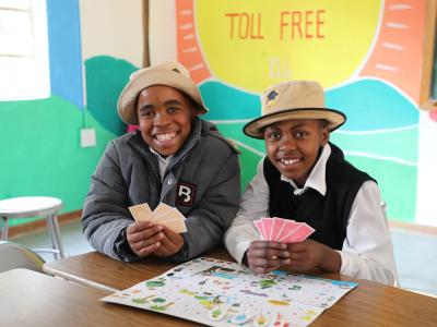Children playing and learning with colorful toys in the Child Friendly Space at Potomane Primary School, showing joy, creativity, and engagement.