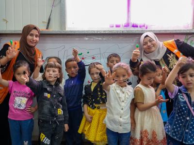 Group photo of children with their teachers in Azraq Camp. 