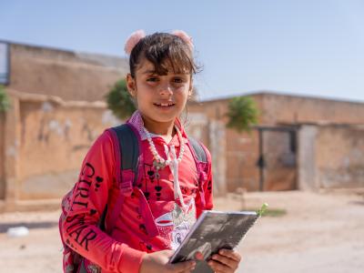 Amal* holding her book, ready for class