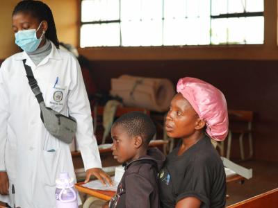 Sitting with her child is Orpa at the accommodation center in Maputo.
