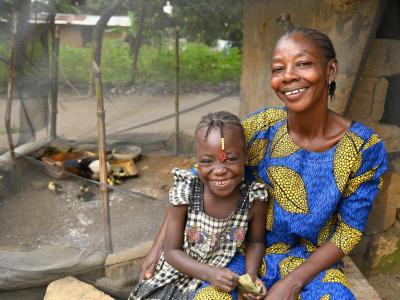 Landrine, 37, and her daughter Nadège, 6, sit side by side, smiling with confidence, reassured that their duck farming is a promise for a better future. 