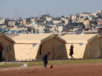 A photo of a child playing with a ball in a displacement camp in Syria