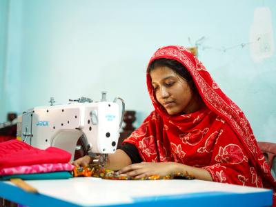 Lovely, a TVET programme participant, working dedicatedly on a sewing machine to build her tailoring business in Khulna, Bangladesh.