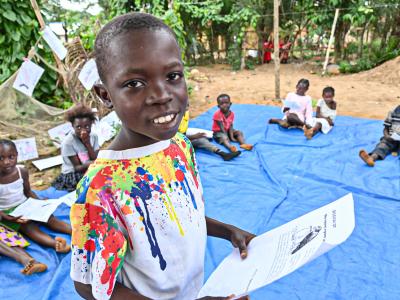 Simon reading in front of other children