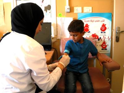 A nurse with a child in the West Bank