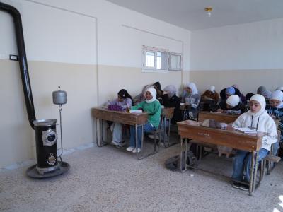 Photo of children in our supported classroom next the heater