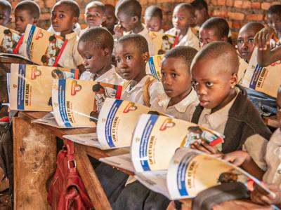 Pupils reading books distributed by World Vision