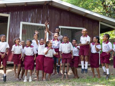 Students posing in front of their renovated classroom