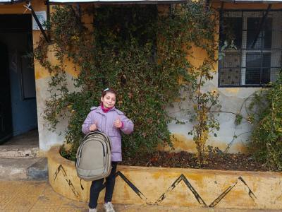 Hala* happy with her new bag at school.