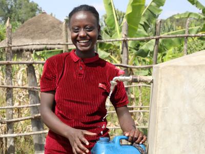A girl filling a bottle of water