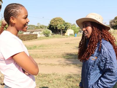 Two people standing and speaking.