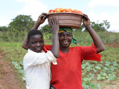 14-year-old Evanildo and his grandmother proudly display their tomato crop in Monapo