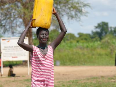Atiek happily carry water home