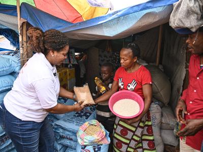 A World Vision staff distributing food to a family