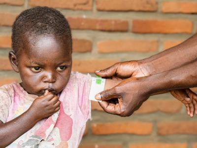 A health worker measuring Gakuru's hand