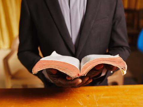 A Pastor in Ghana holds his Bible