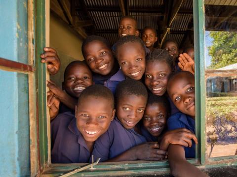 School children looking through window
