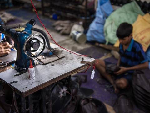 Jatin, 13, works in a textile factory in India