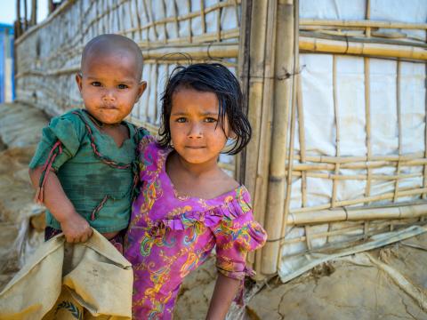 A girl holds her young brother