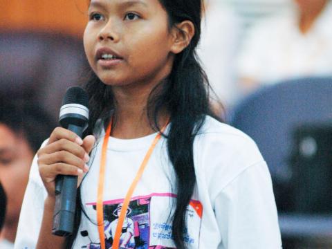 Young Khmer lady speaking on a microphone