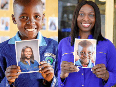 Mary and Yinka holding each other's photos