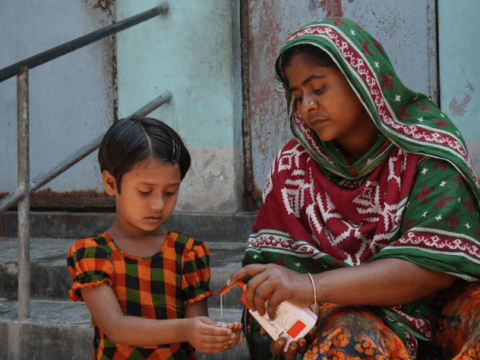 Mother and daughter washing hands during covid-19 response