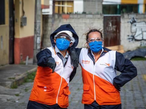 Two World Vision staff members is protective gear against COVID-19