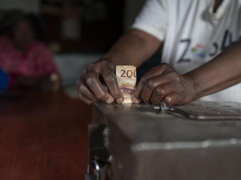 Someone holding a 200 money bill