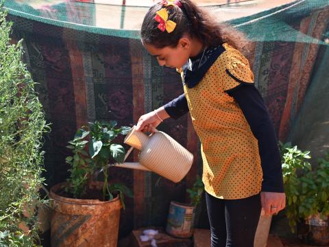 A girl watering her plants