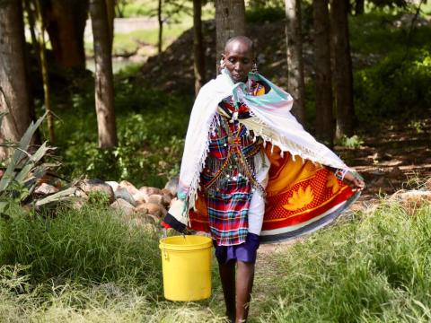 A woman carries water