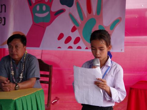 Namvanh shares a story during a community event of the It Starts With Me campaign in Laos