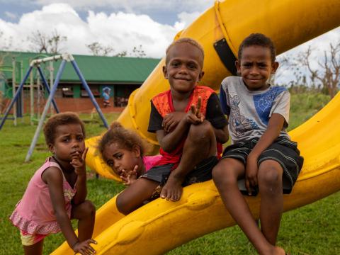 Children and families shelter in a school after a cyclone in Vanuatu