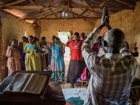 Janet's mother, Joyce Mulungi, 47 (in blue), attends a service at Mayirikiti Redeemed Church in Nakasongola, Uganda