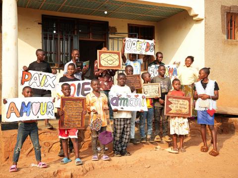 Children holding signs about peace and love 