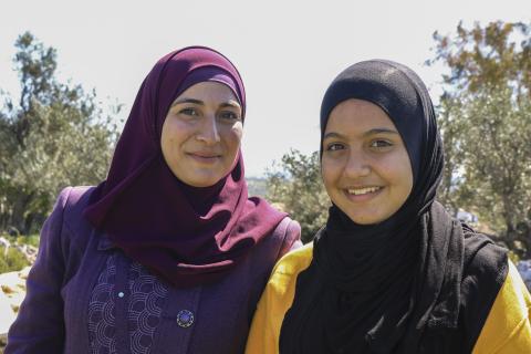 mother daughter and bee keepers smiling at the camera