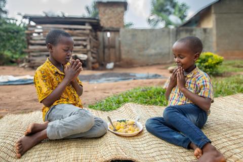 Javira praying with his sibling