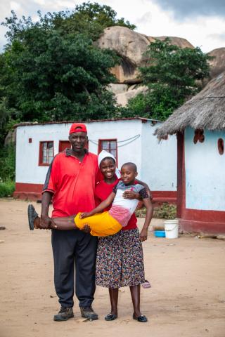 Musande and Ngoni pose for a photo with their daughter Jesca