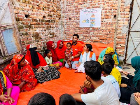 Mukta and community members in Amtali sitting together during a cleanliness and hygiene awareness session. 