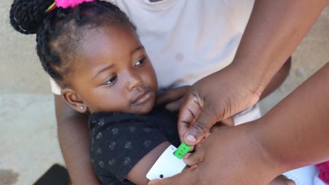 A MUAC tape reading showing a healthy child during routine growth monitoring.