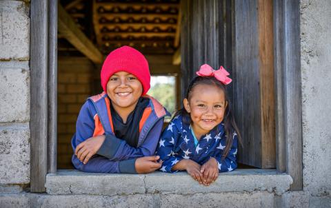 Max and Lusi smiling at the camera at their grandmother’s home. Honduras, 2025.