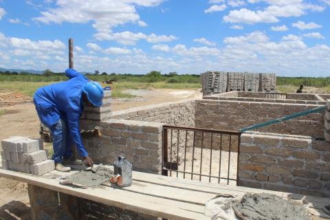 Patrick mixing cement during construction work
