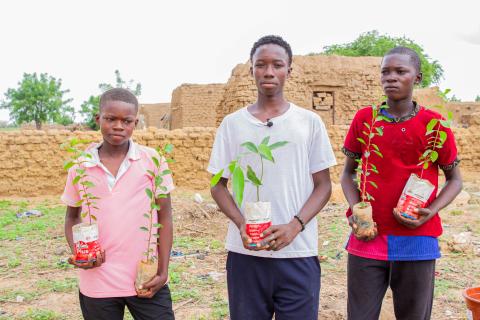 Each child received four fruit trees, including mango, guava, lemon, and orange trees, to plant in their households