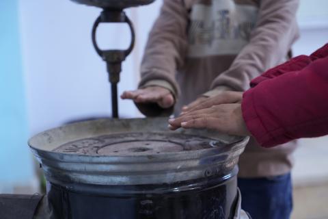 Children using the heater in class during the cold winter