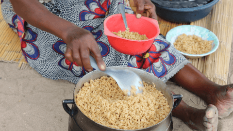 Salfina serves her grandchildren  